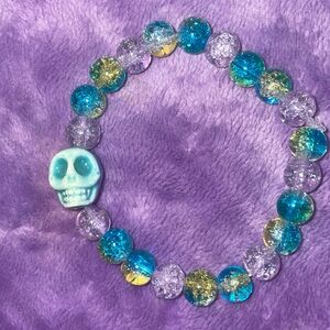 Glass marble beads , with skull pendent .